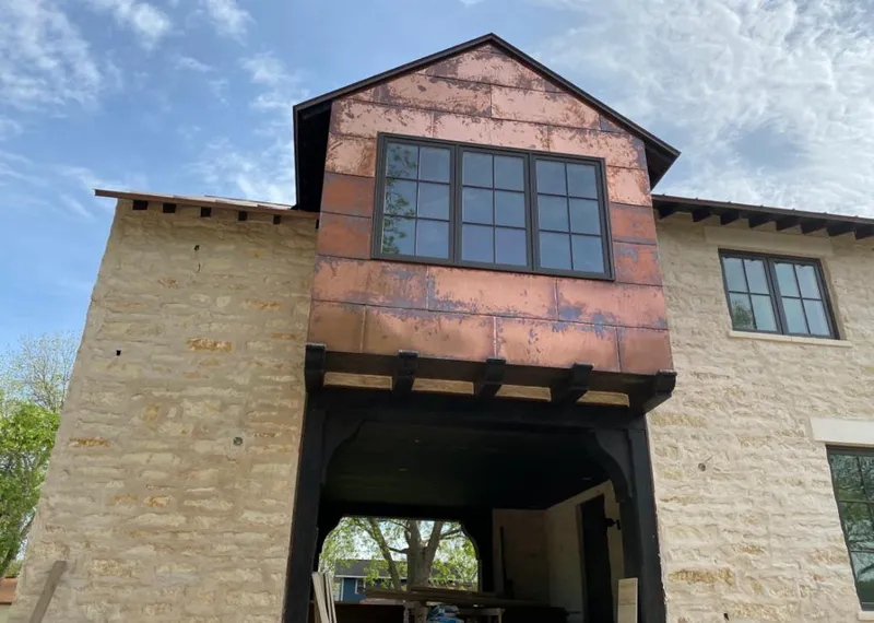 Copper metal panel facade on a stone building for Metal Roof Coating in Wyandotte