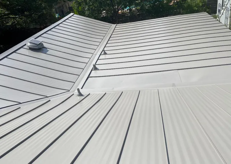 Solar attic fan installed on a metal roof for Roof Ventilation in Wyandotte